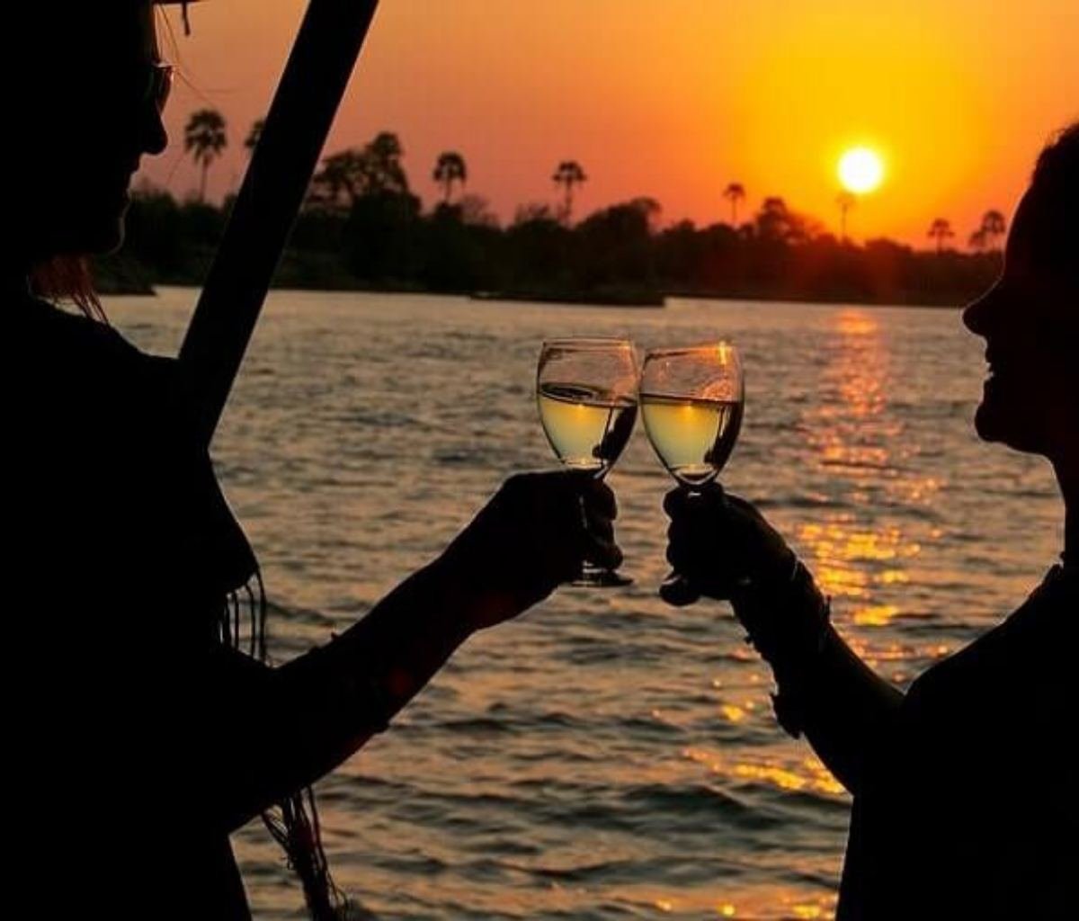 Couple toasting to a Victoria Falls stay on a sunset cruise