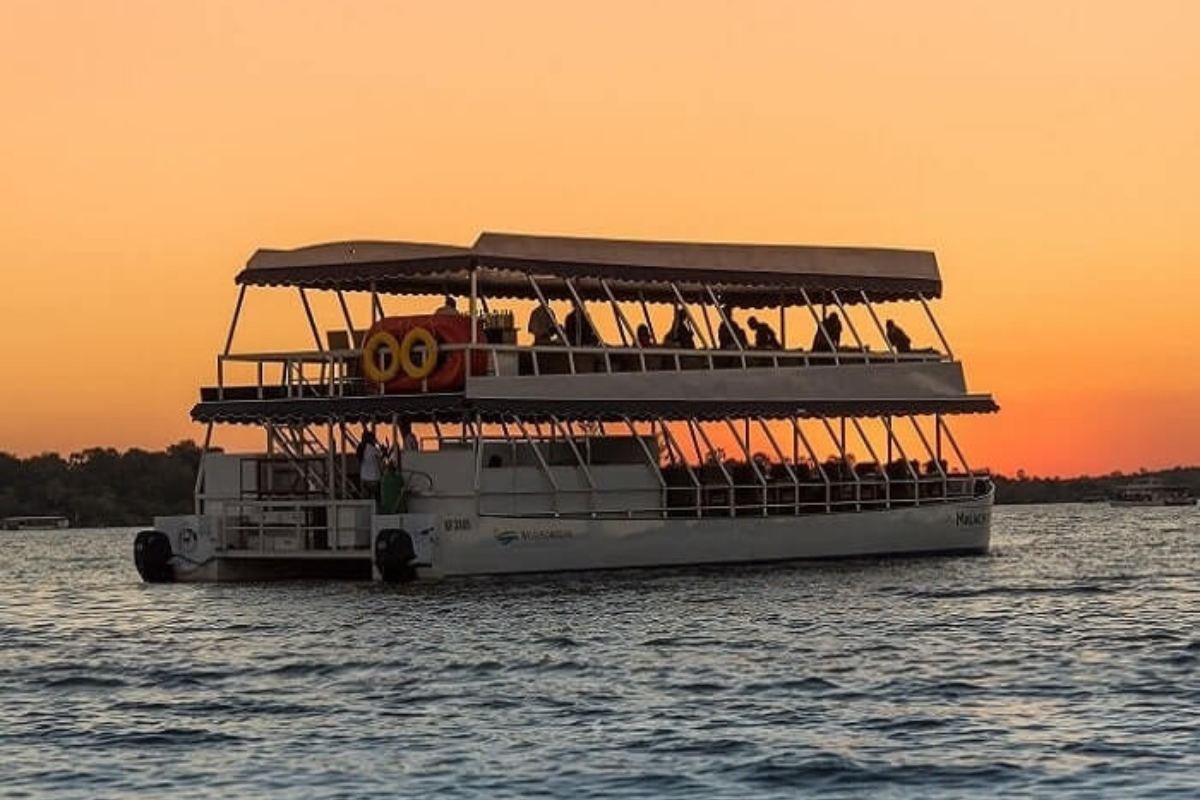 Tourists enjoying an African sunset on the Zambezi river