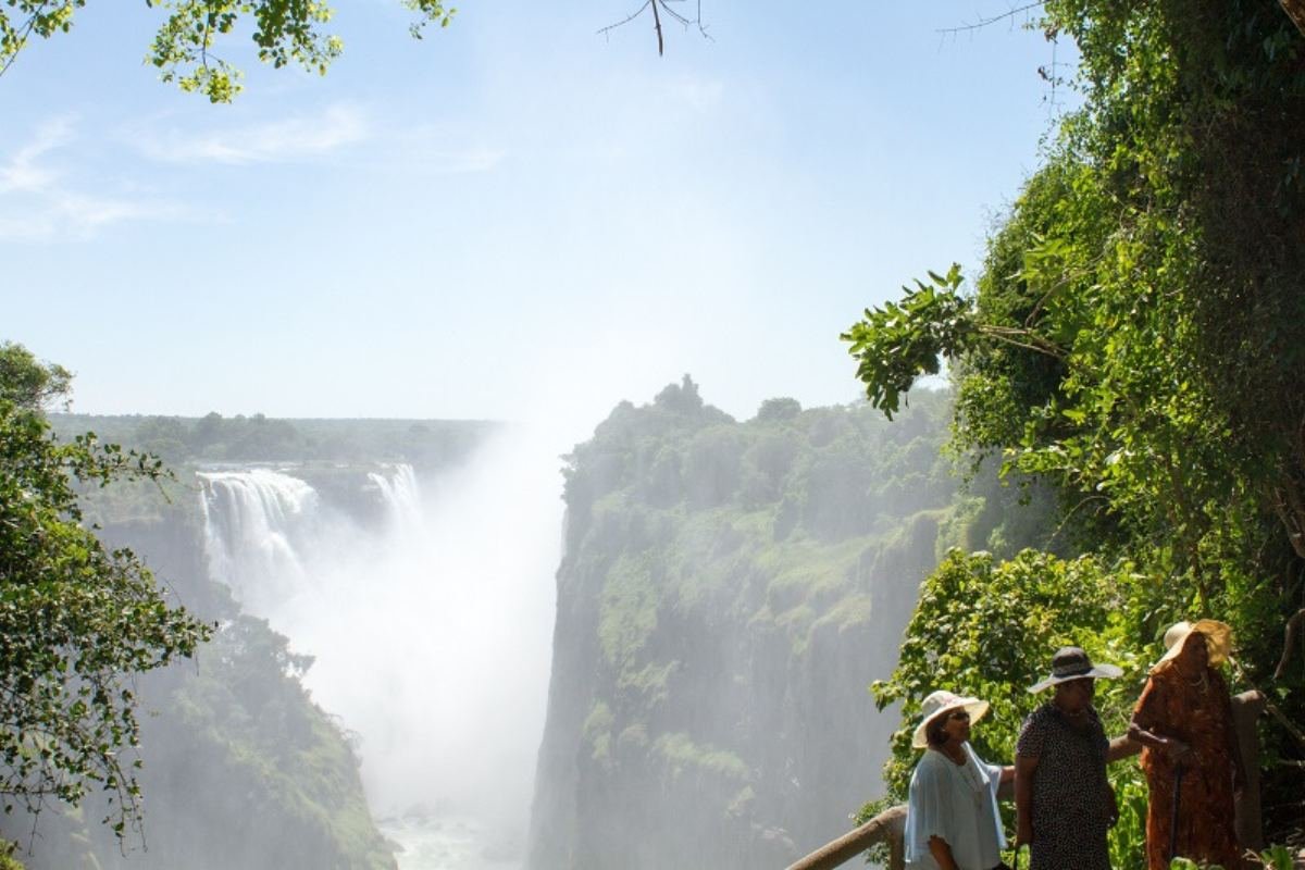Guests enjoying the spray of the majestic Victoria Falls