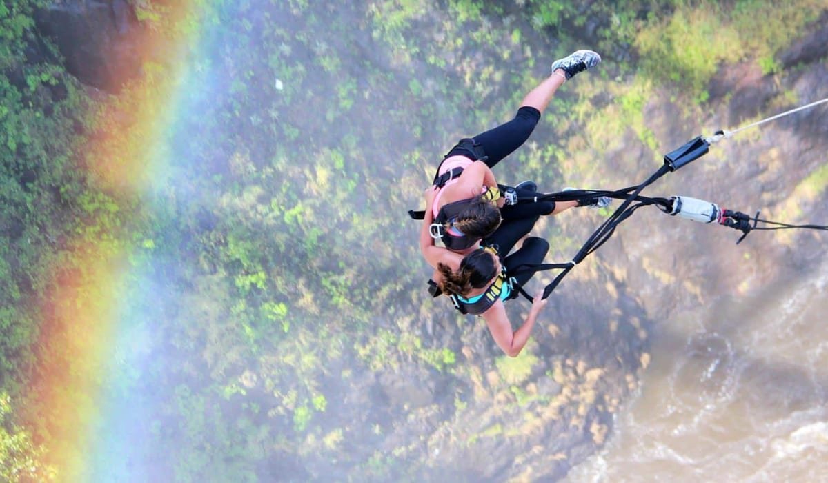 Bungee jump at Victoria Falls with a rainbow over the gorge